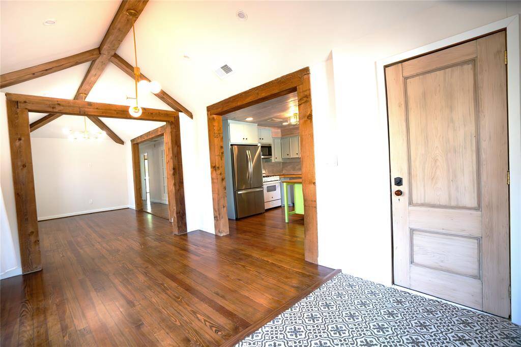 Completely open view of entry, dining and living room.