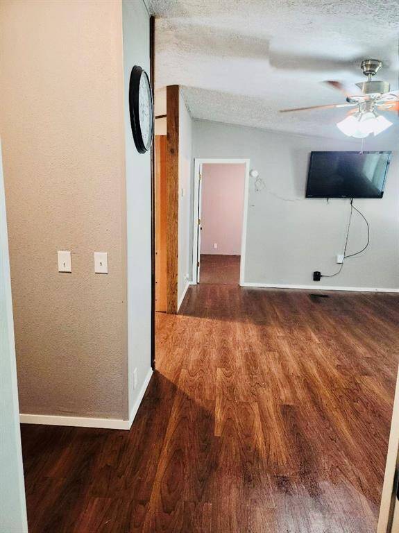 View from the far side of the main living area into the primary bedroom.