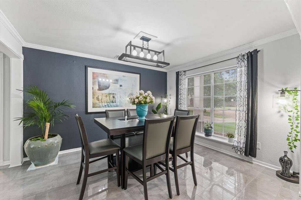 The spacious living area flows effortlessly to the dining and kitchen spaces, creating an ideal setting for entertaining.