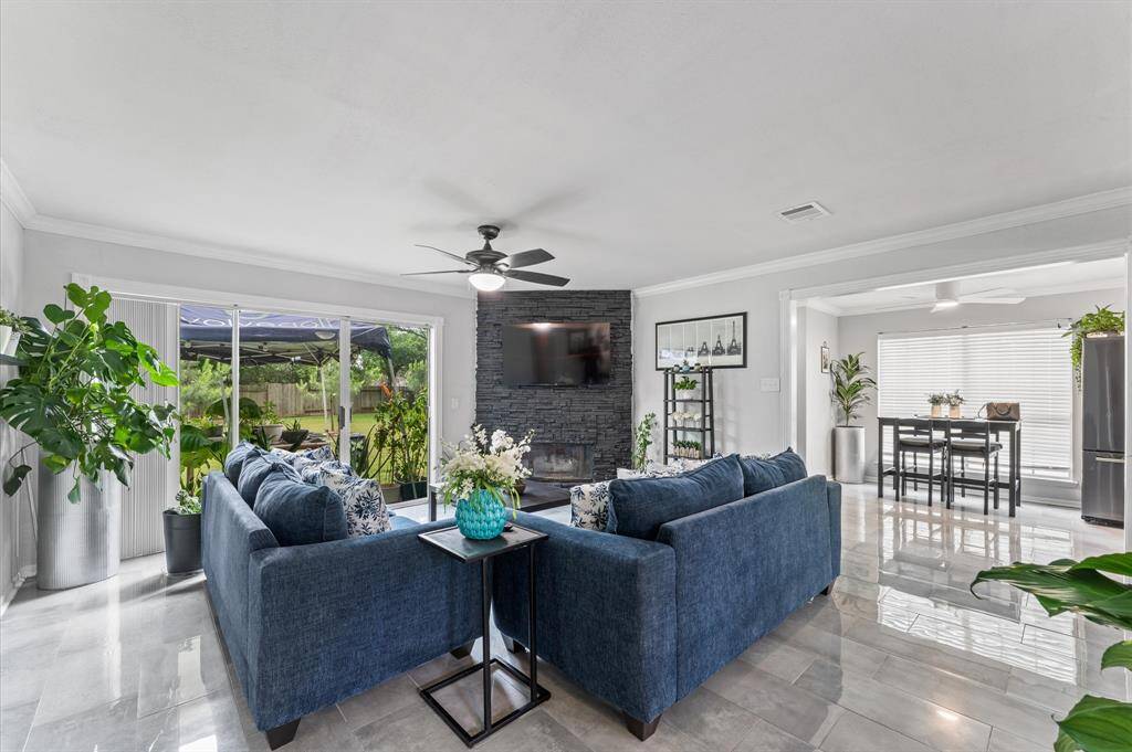 The spacious living area flows effortlessly to the dining and kitchen spaces, creating an ideal setting for entertaining.