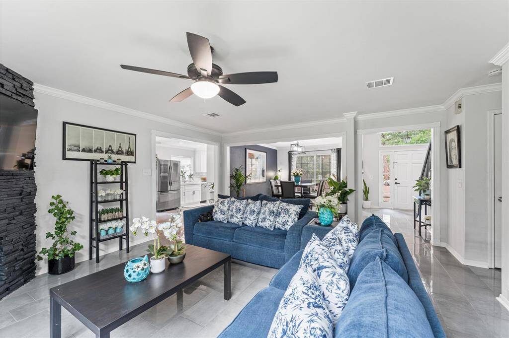 The spacious living area flows effortlessly to the dining and kitchen spaces, creating an ideal setting for entertaining.