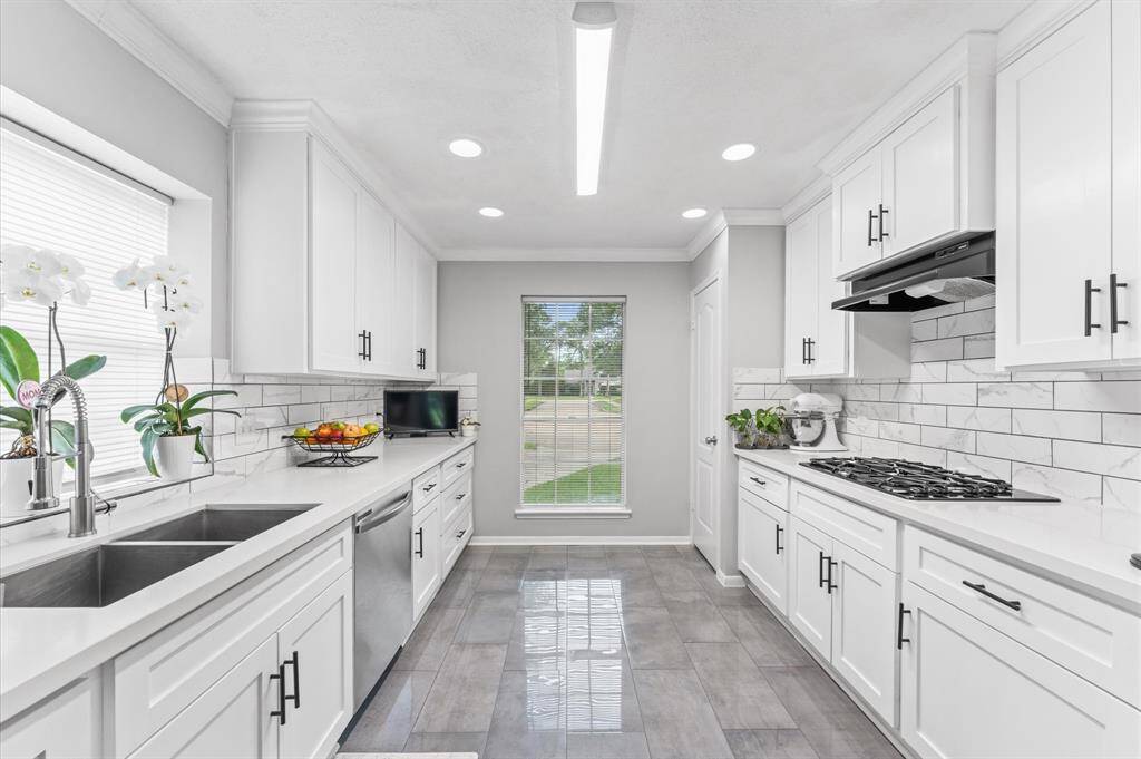 Immaculate completely reimagined kitchen with quartz countertops and stainless steel appliances.