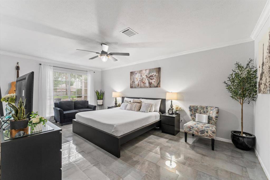 The serene primary suite boasts a spa-like en-suite bathroom with luxurious walk-in shower, sleek tilework, and a walk-in closet.