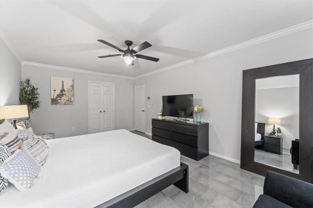 The serene primary suite boasts a spa-like en-suite bathroom with luxurious walk-in shower, sleek tilework, and a walk-in closet.