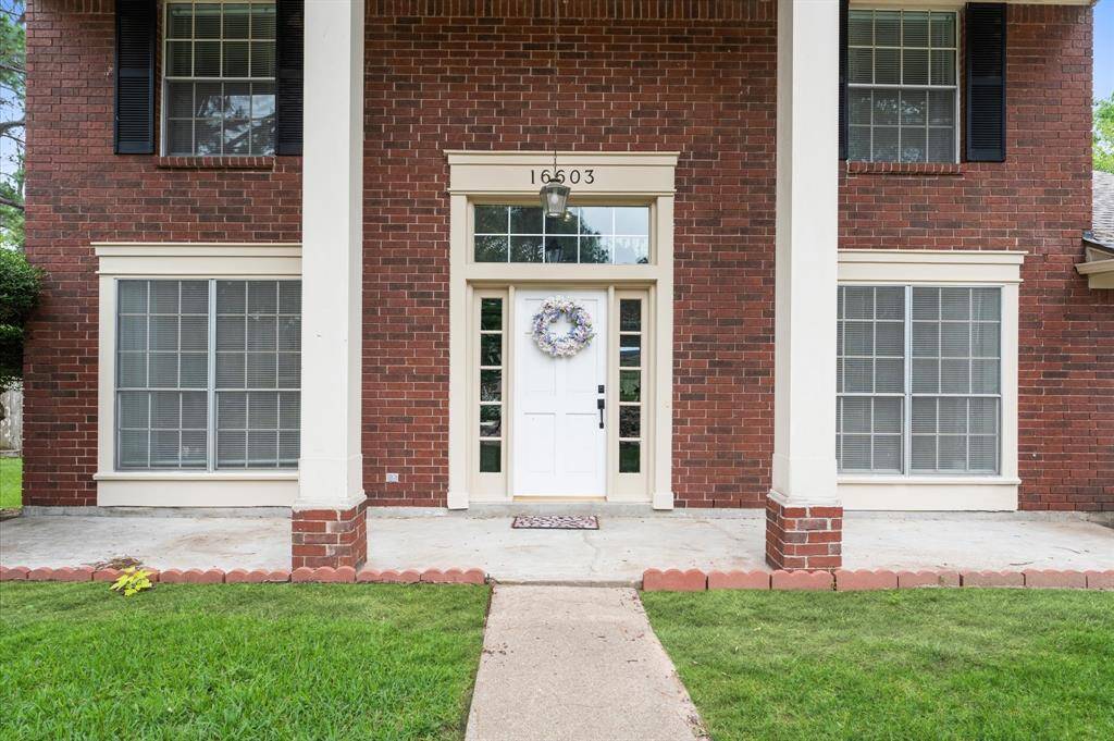 Stunning curb appeal, featuring a stately front facade with decorative pillars
