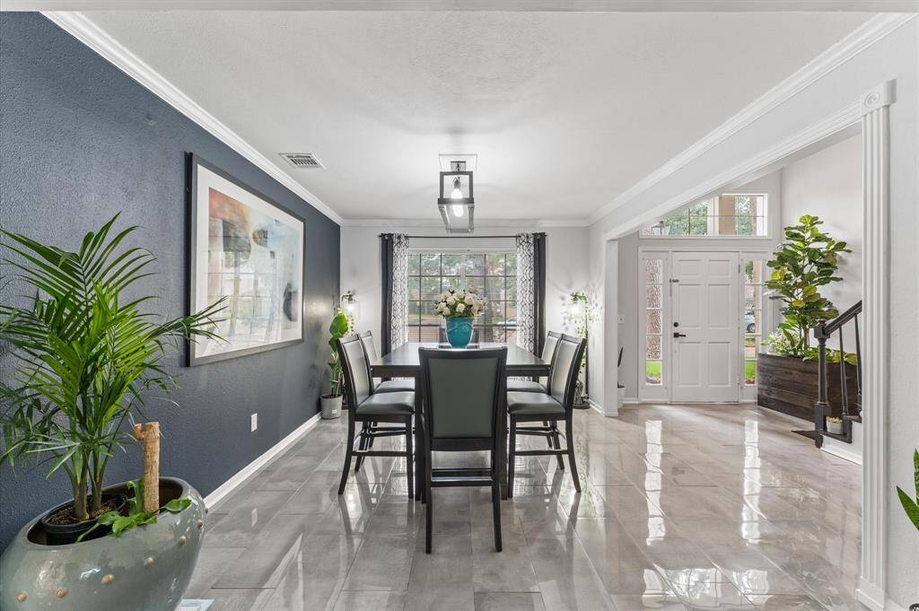 The spacious living area flows effortlessly to the dining and kitchen spaces, creating an ideal setting for entertaining.