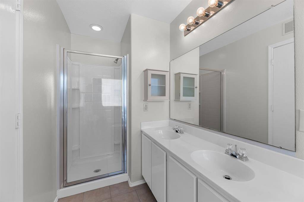 The primary bath has double sinks and a separte shower