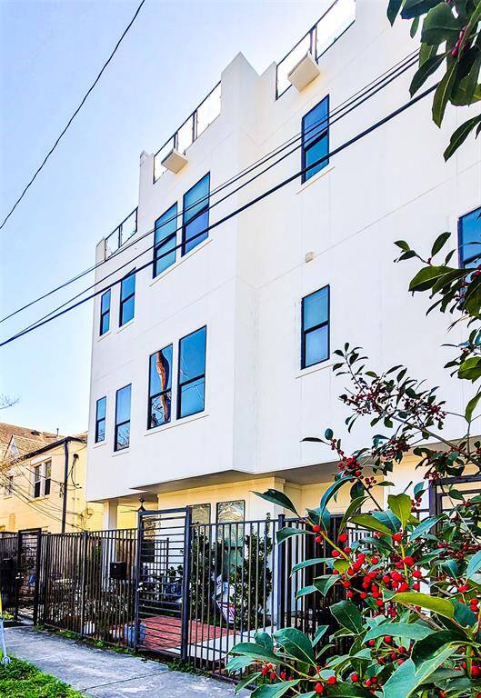 Multi-story home features a sleek white and stunning Stucco exterior. Enjoy a private, gated front entrance.