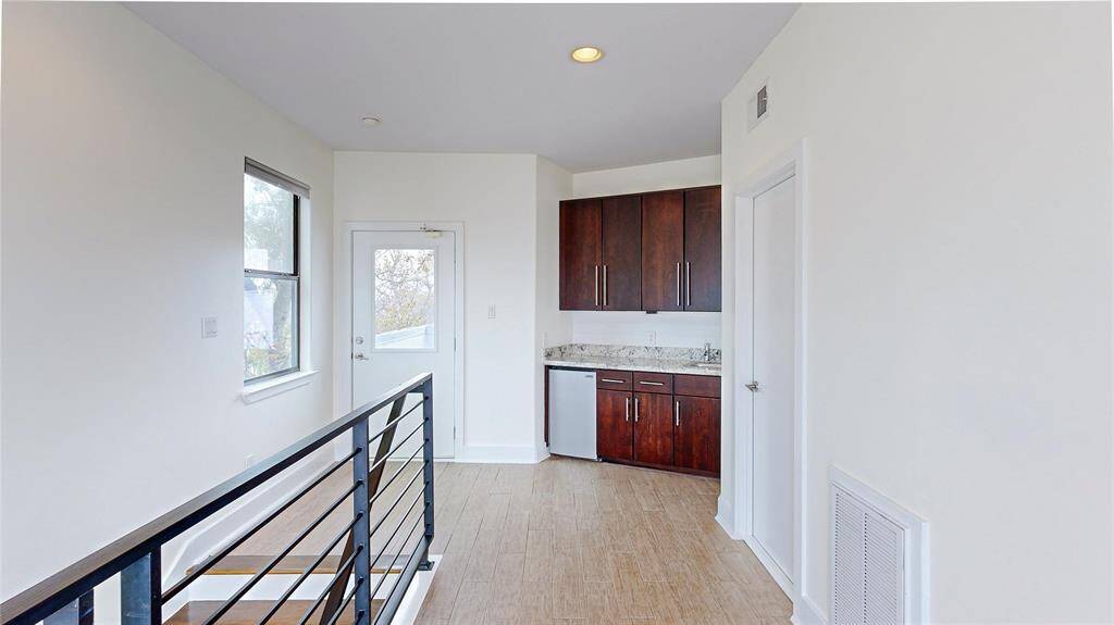 On the 4th Level, leading to the two rooftop balconies, is this wonderful feature, a kitchenette with a mini fridge, sink, and storage space. There is plenty of room for adding a seating area.