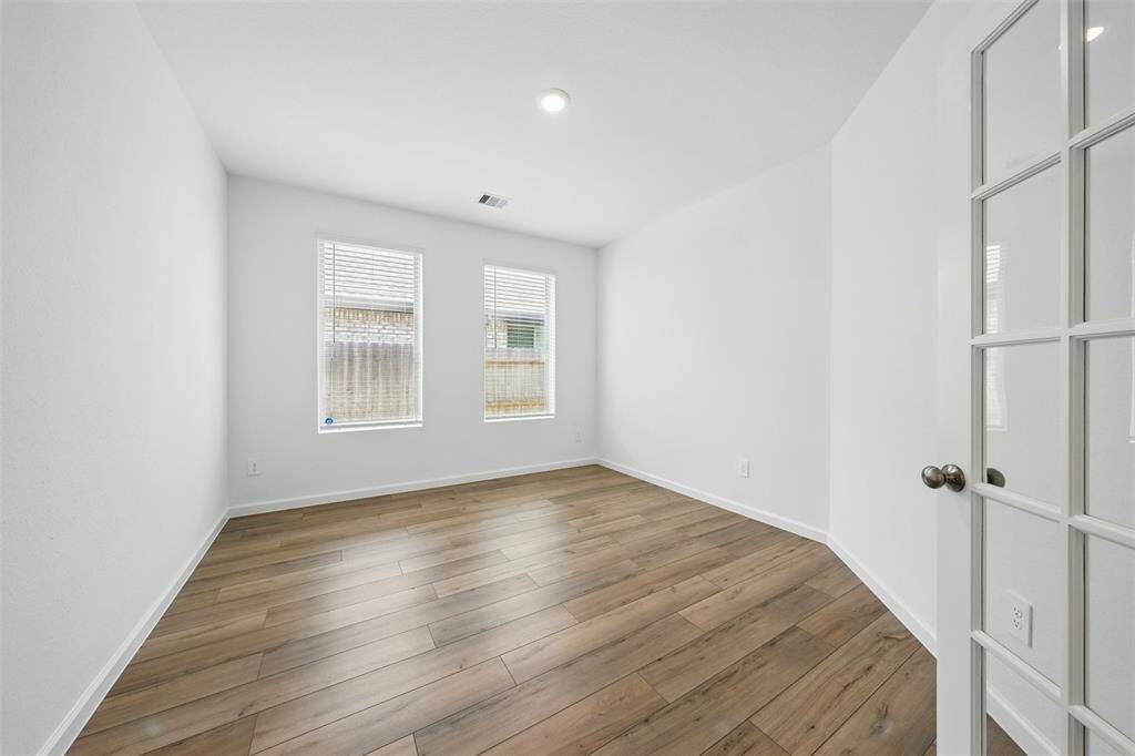 Study/Office Room: At the end of the hallway, you'll find a versatile study or office room, complete with elegant French doors that allow natural light to come to the space, creating an ideal environment for work or relaxation.