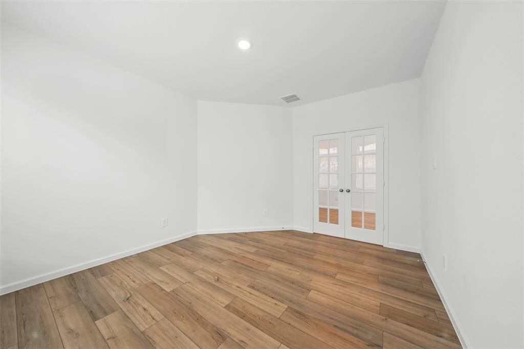 Study/Office Room: At the end of the hallway, you'll find a versatile study or office room, complete with elegant French doors that allow natural light to come to the space, creating an ideal environment for work or relaxation.