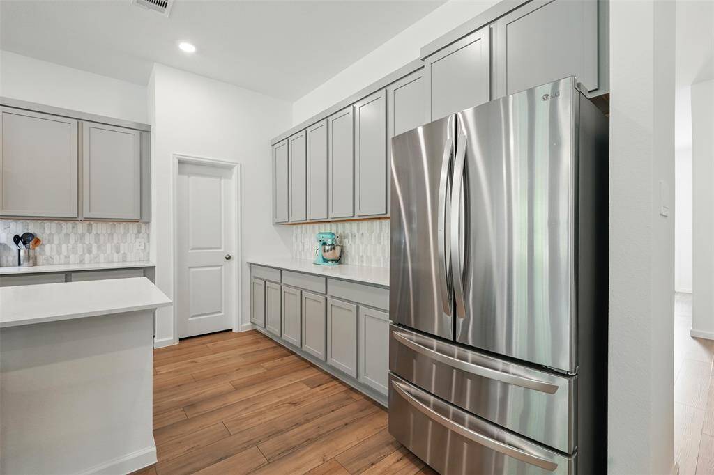 A walk-in pantry tucked between the cabinets for extra storage.