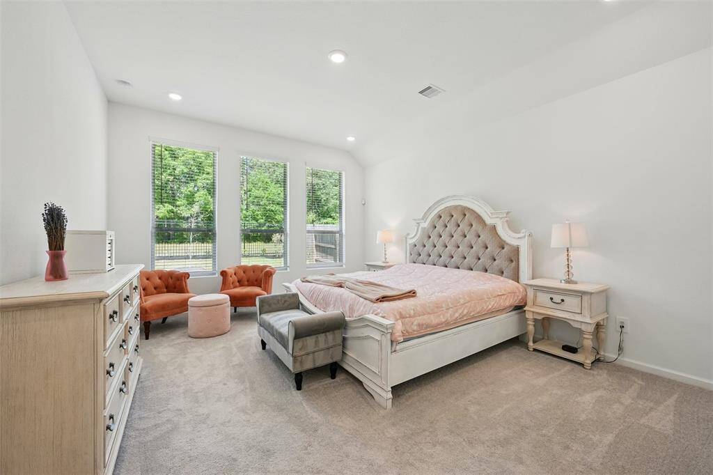 Primary Bedroom: Provides a direct view of the forest, creating a tranquil retreat that easily fits a king-size bed and a cozy set of reading chairs.