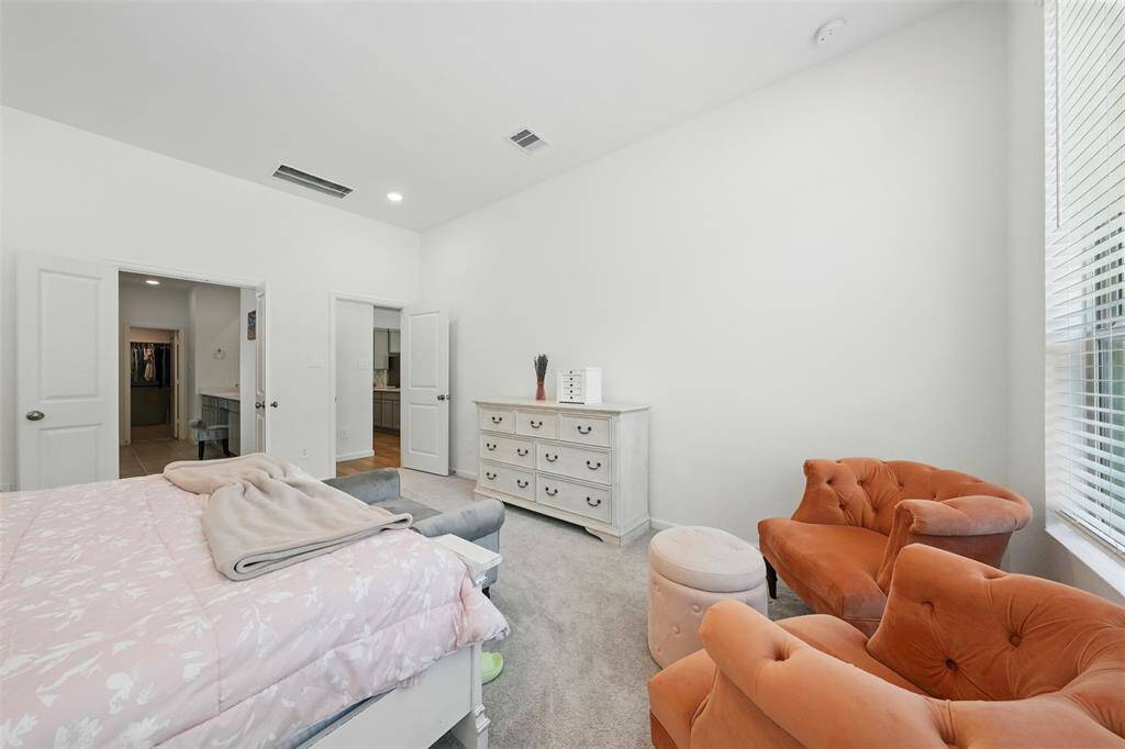 The primary bedroom is thoughtfully designed and separated from the guest bedrooms for added privacy.