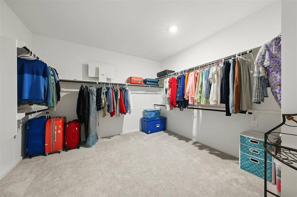 The primary bedroom features a large walk-in closet that conveniently connects to the laundry room, adding ease to your daily routine.