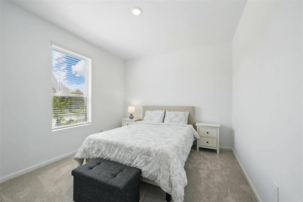 Bedroom 1: To the left of the front entrance, you'll find a charming guest/in-law room that offers a peaceful view of the front yard, providing a private and comfortable space for visitors.