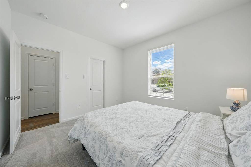 Bedroom 1: To the left of the wide and welcoming front entrance, there's a private guest or in-law room featuring its own closet and a lovely view of the front yard—perfect for visitors or multigenerational living.