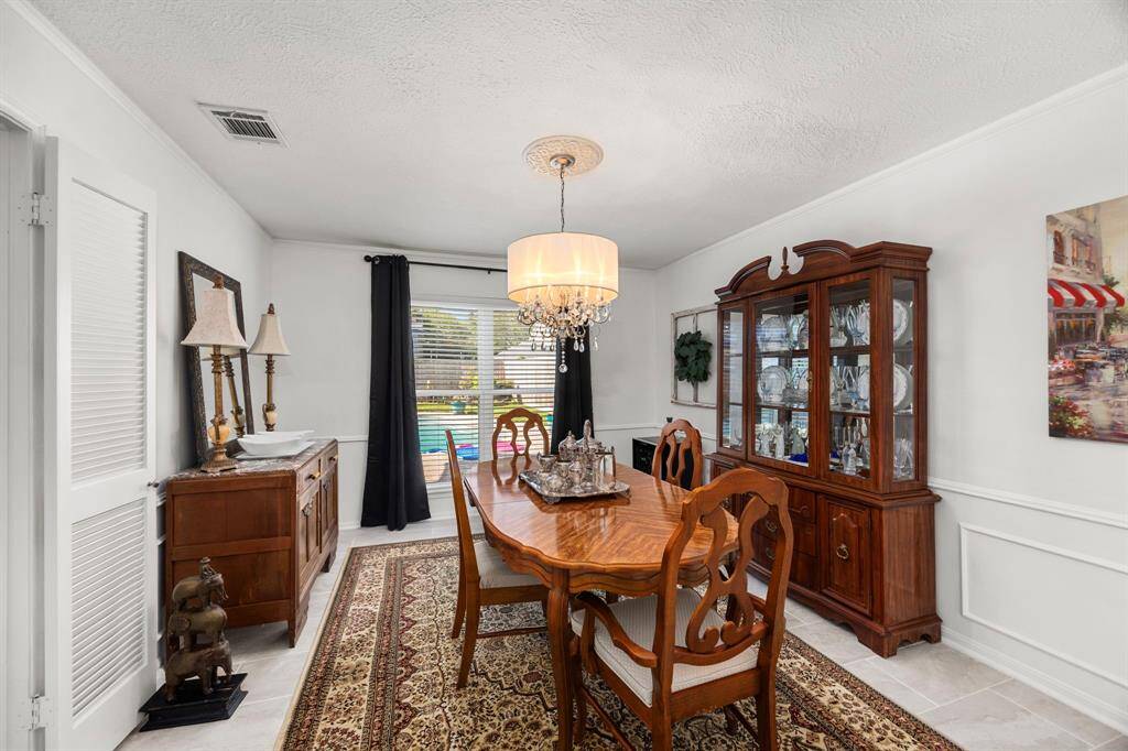 Dining room has tile floors and overlooks pool.