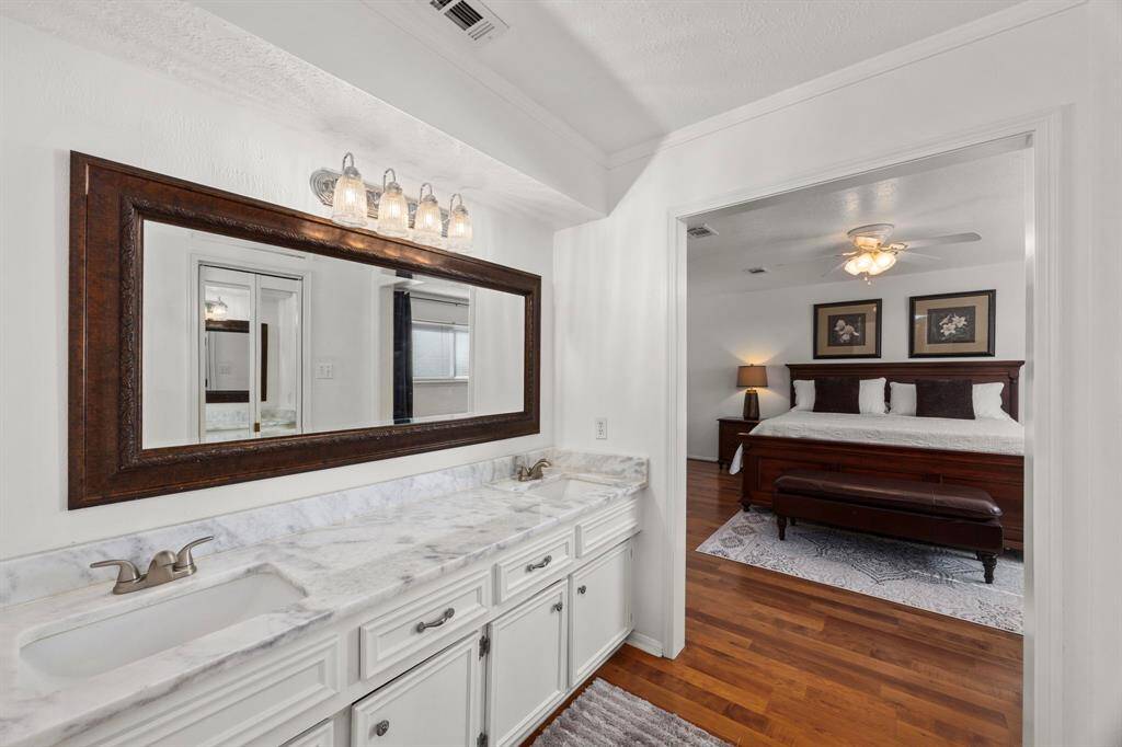 Primary bath has laminate floor and walk-in closet