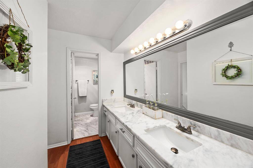 Hall bath recently remodeled with new counters, sinks, toilet, combo tub/shower