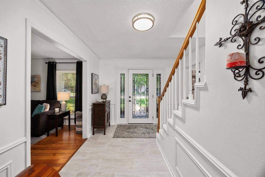 Front entry features a beautiful front door with side lights, tile flooring, crown and picture molding.
