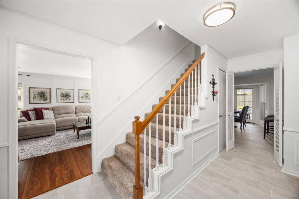 Family room is left of entry with carpeted stairs
