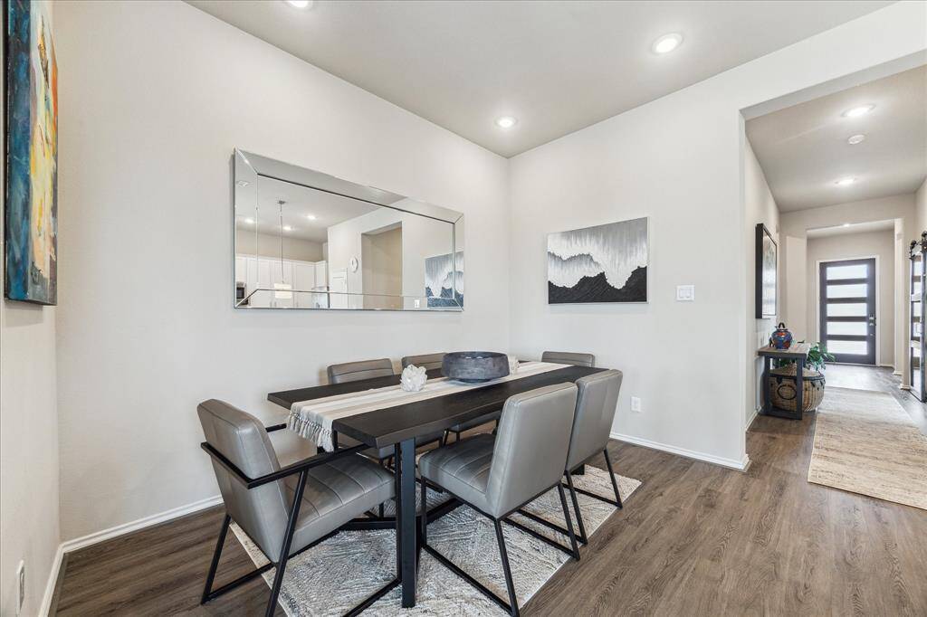 Your friends and family will love breaking bread with you in this spacious, open dining area featuring neutral paint, recessed lighting, and durable LVP flooring that flows seamlessly through the main living spaces.
