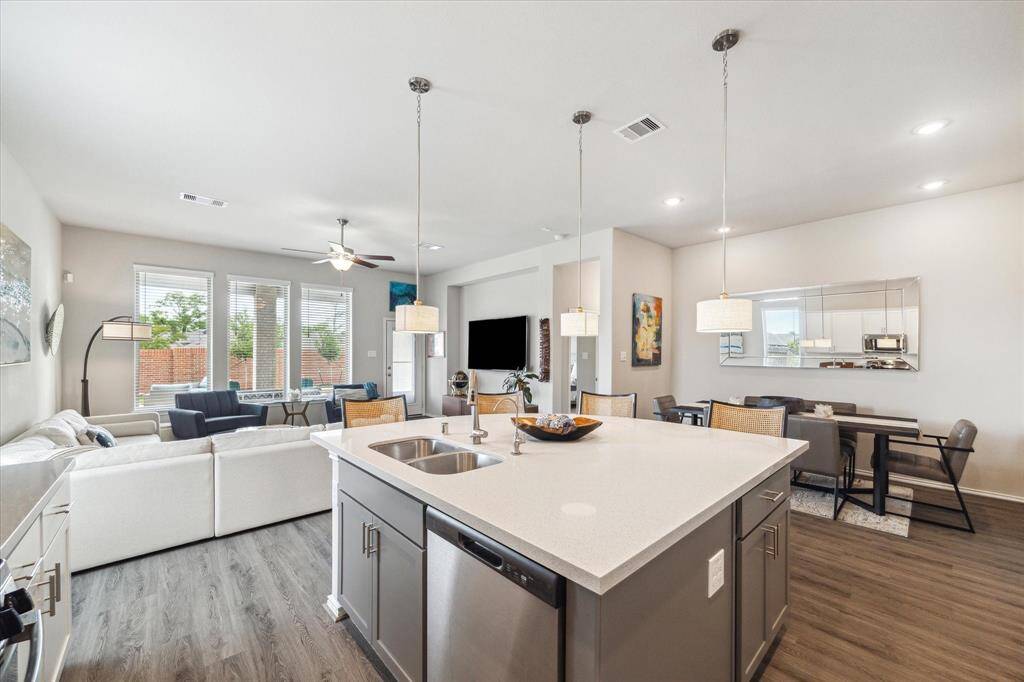 Thanks to the open layout, the kitchen, dining area, and family room flow together seamlessly, making it easy to mingle with guests while you cook or serve. Enjoy stylish lighting throughout and clear views of the patio and pool that keep you connected to the action inside and out.