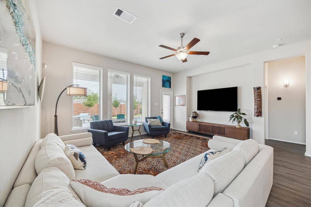 This expansive family room offers plenty of space to spread out and unwind, whether you're hosting friends or relaxing after a sunny day by the pool. It’s the perfect blend of comfort and functionality for everyday living and effortless entertaining.