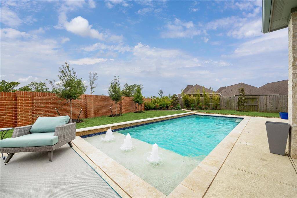 Texas summers just can't be beat when you can enjoy your own backyard swimming pool, complete with tanning ledges, water features, and plenty of space to splash, soak, or simply chill in the sun