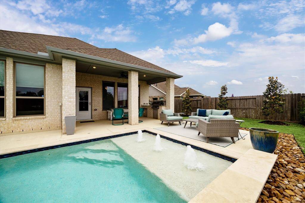 Kick back and soak up the good life whether you're stretched out on a lounger, dipping your toes in the water, or enjoying lunch poolside under the covered patio. With this backyard setup, every day feels like a mini vacation.