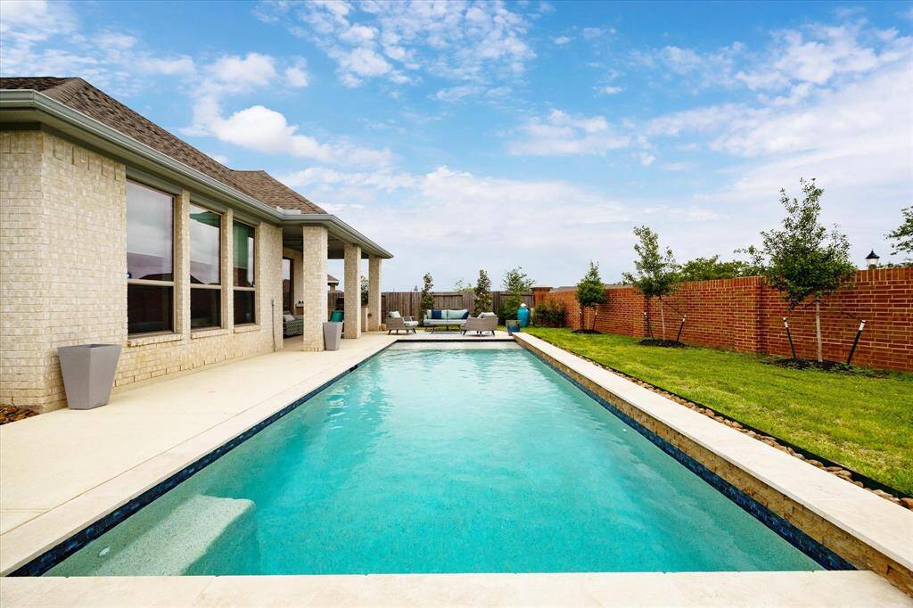 Dive right in, the water’s perfect! This sparkling inground pool features soothing water features and tanning ledges, all surrounded by a spacious patio perfect for lounging or entertaining.
