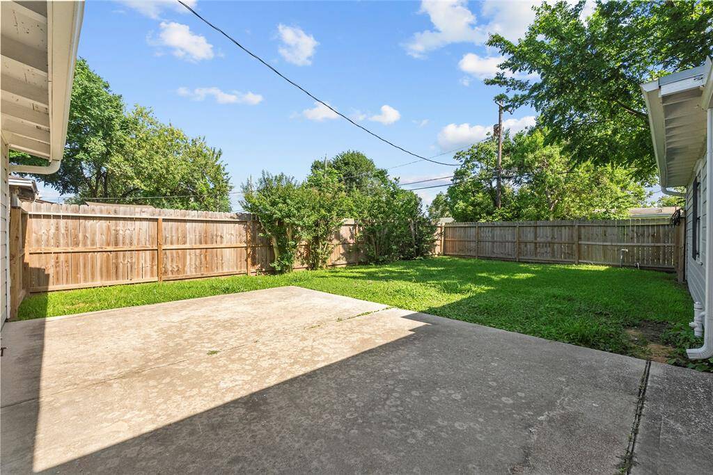 Paved backyard slab with open yard green space