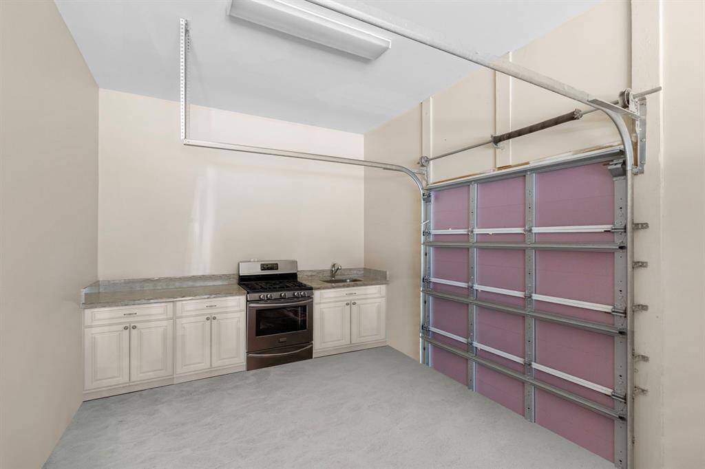 1 of the garage space with a built-in kitchen area