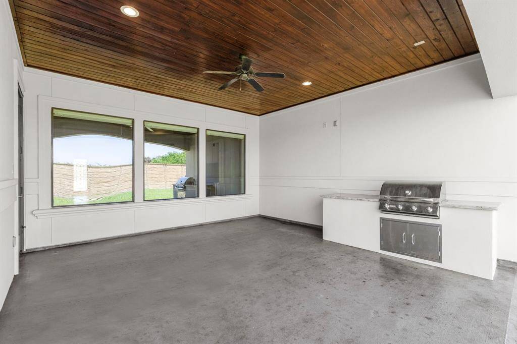 Large covered patio with outdoor kitchen. A quiet area to unwind + ceiling fan to keep you cool.