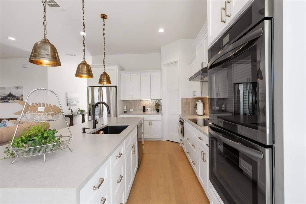 This kitchen is perfect for gatherings with friends and family, with the large island and the flow into the living and dining areas.  The lake view makes this an exquisite space to entertain or just relax with your favorite people!