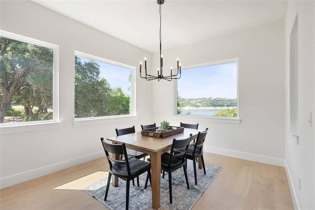 Dining area off of kitchen has a natural design and also has a great view of the lake and lush greenery around this home and plenty of beautiful, natural lighting.