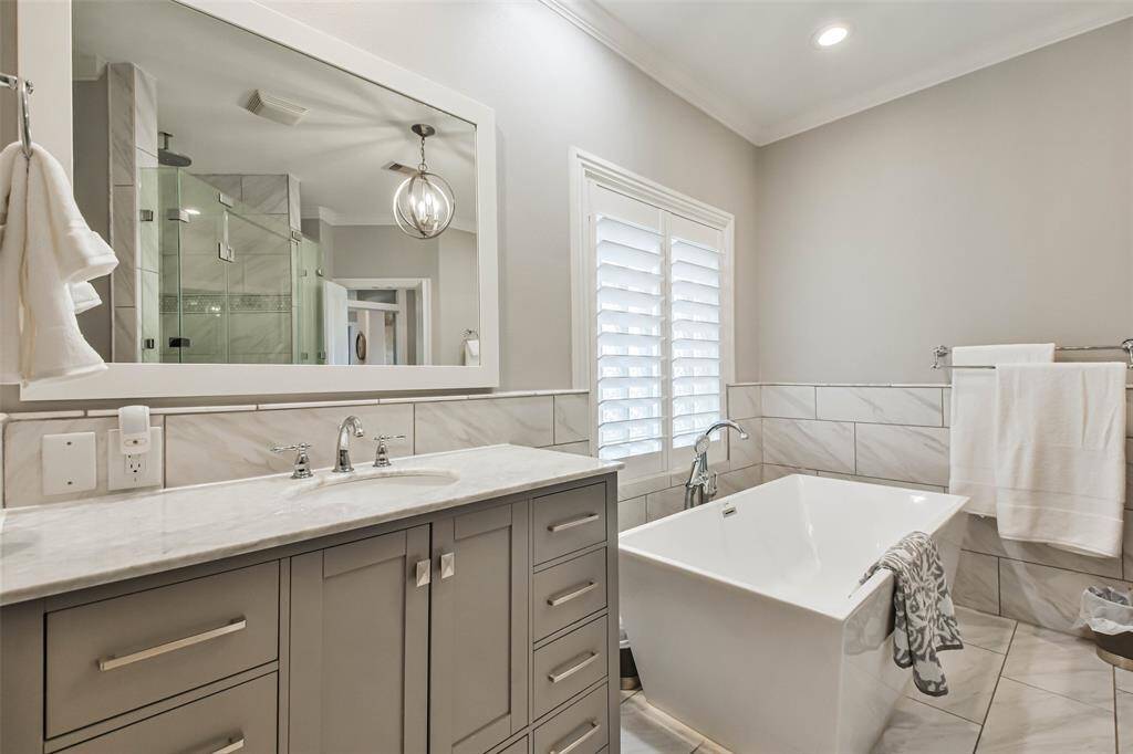 Primary Bathroom has double sinks on sophisticated countertops !!