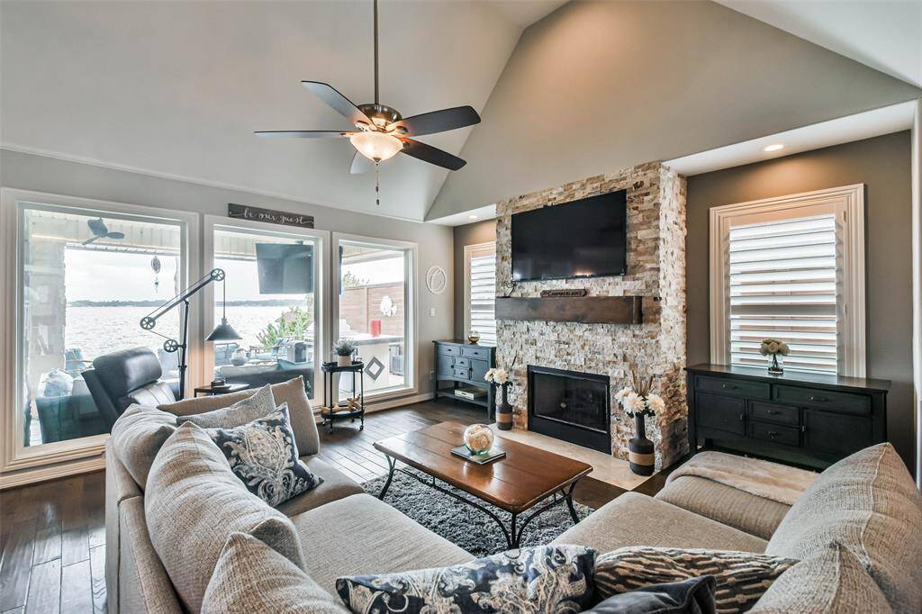 This exquisite two-story home features an open-concept living area with a gourmet island kitchen, complete with stainless steel KitchenAid appliances and rich wood flooring..