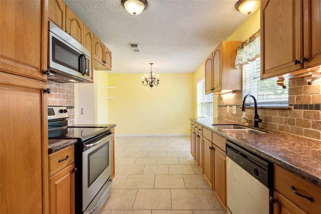 Granite countertops, stainless steel appliances that are built in. Breakfast/Dining area located in the back.