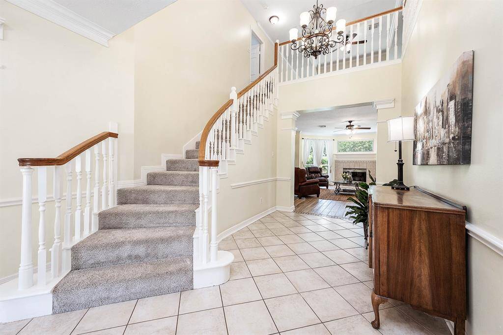 Elegant 2-story entrance with a view into the inviting family room.
