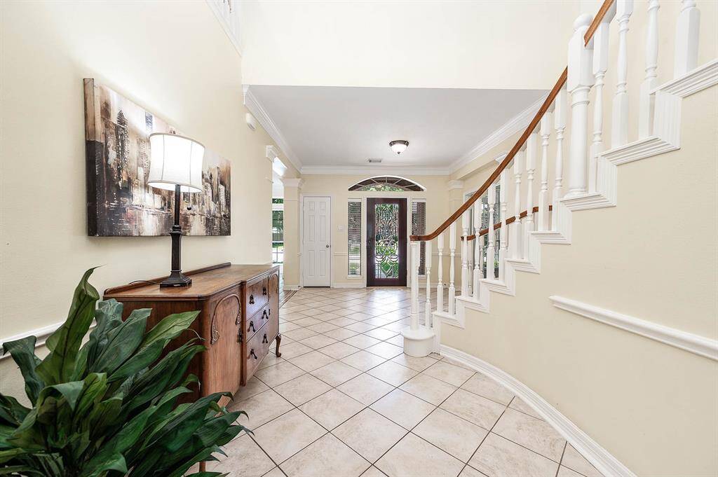 The stunning etched glass that graces the elegant front door welcomes you home.