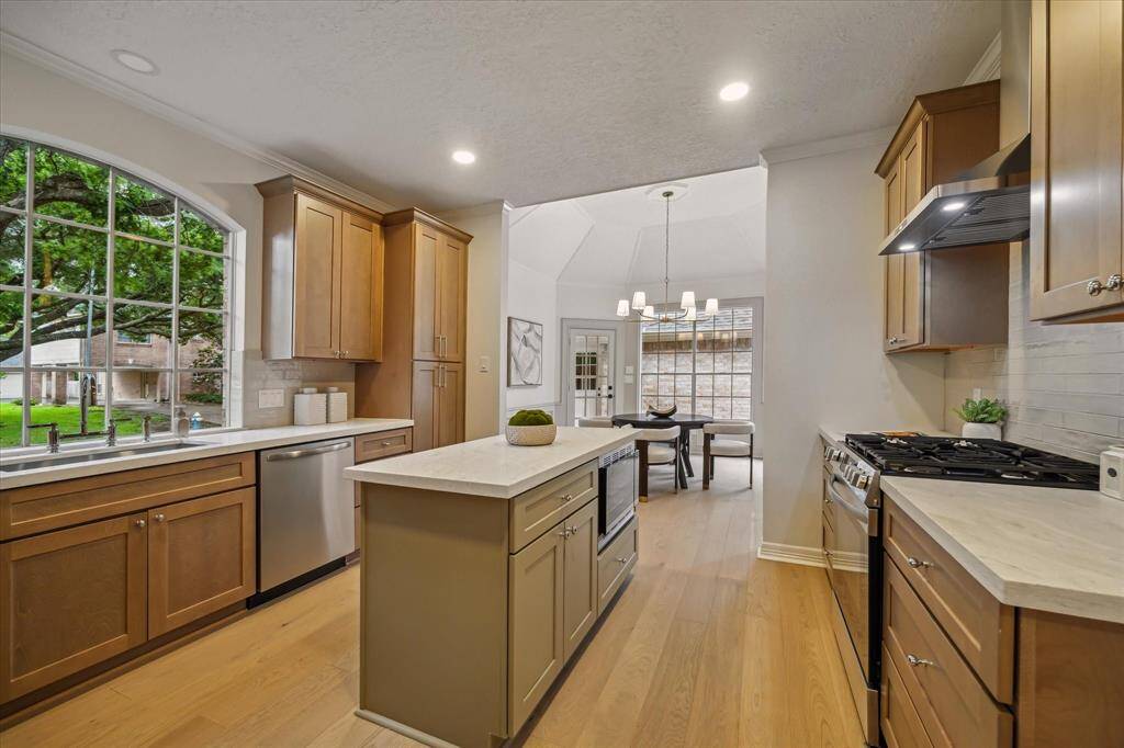 THE HEART OF THE HOME HAS BEEN UPDATED WITH SLEEK COUNTERS & STAINLESS STEEL APPLIANCES; INCLUDING AN UNDER COUNTER MICROWAVE.