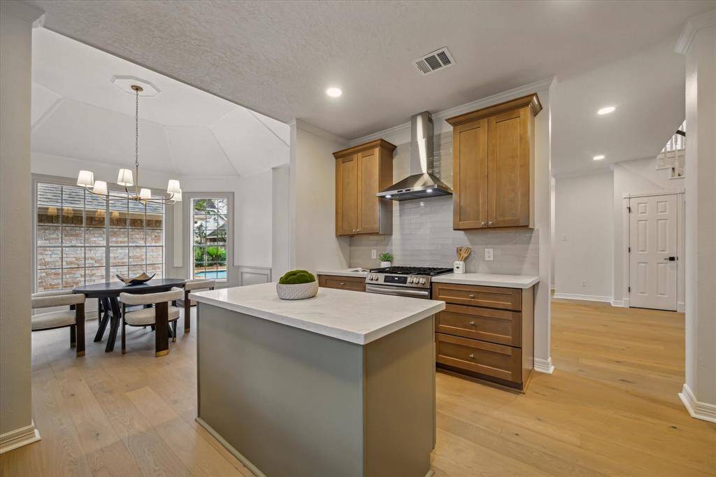 COOKING AND SERVING ARE A BREEZE WITH AN ABUNDANCE OF COUNTER SPACE. STAINLESS STEEL HOOD AND CUSTOM TILE BACKSPLASH RECENTLY INSTALLED.