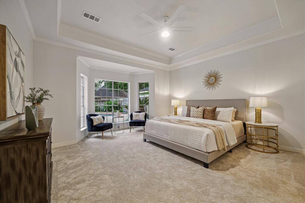 ESCAPE TO THE PRIMARY RETREAT, WITH BAY WINDOW VIEWS OF THE POOL, FOR RELAXATION AND REJUVENATION.