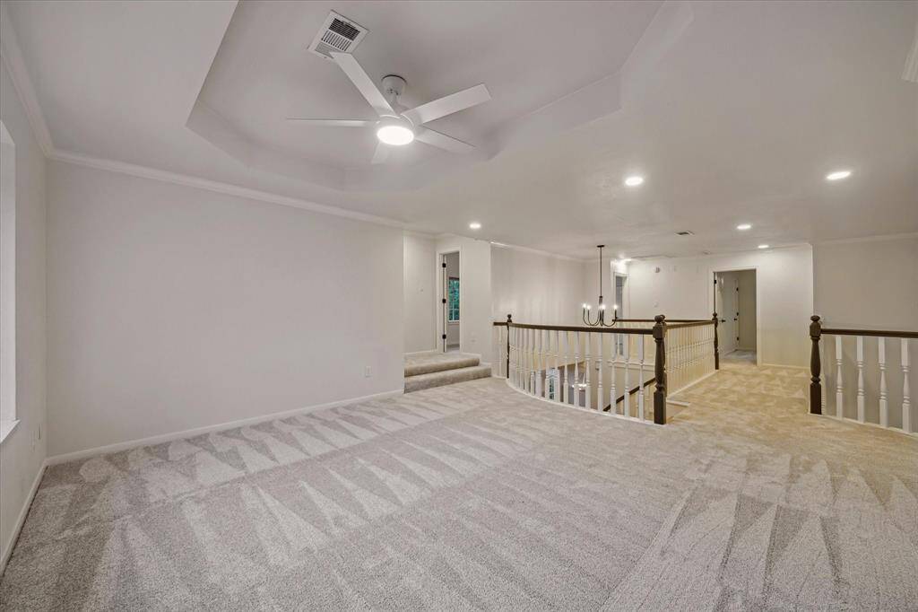 OPPOSITE VIEW OF THE GAMEROOM WITH 2 STEPS LEADING TO BEDROOMS.