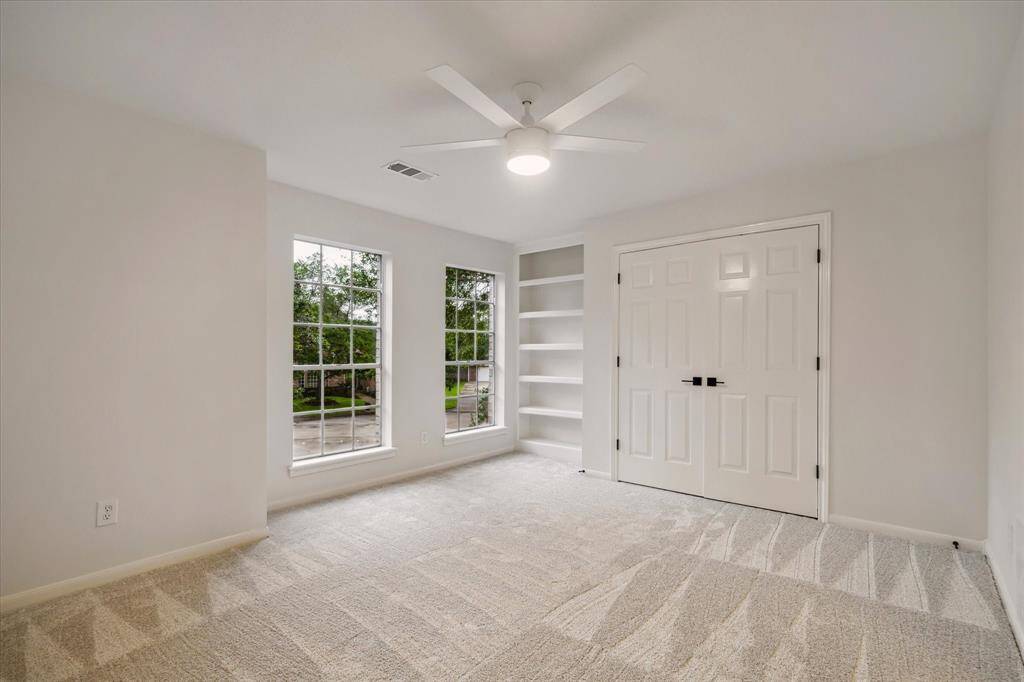 BEDROOM 4 OFFERS CUSTOM BOOKSHELVES.