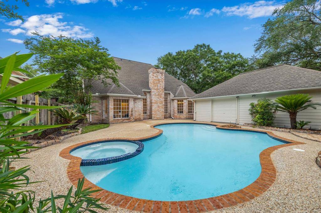 DIVE INTO SUMMER! THE GUNITE POOL WITH THE ATTACHED SPA IS READY FOR FUN.