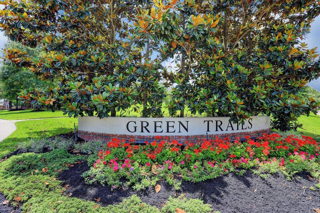 BEAUTIFUL NEIGHBORHOOD ENTRANCE IS WELL-MAINTAINED WITH SEASONAL FLOWERS.