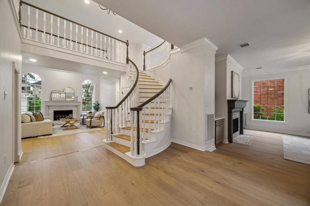 AS YOU ENTER THE HOME, PREPARE TO BE WOWED BY THE CURVED STAIRCASE, IDEAL FOR FUTURE PROM & GRADUATION PHOTOS.